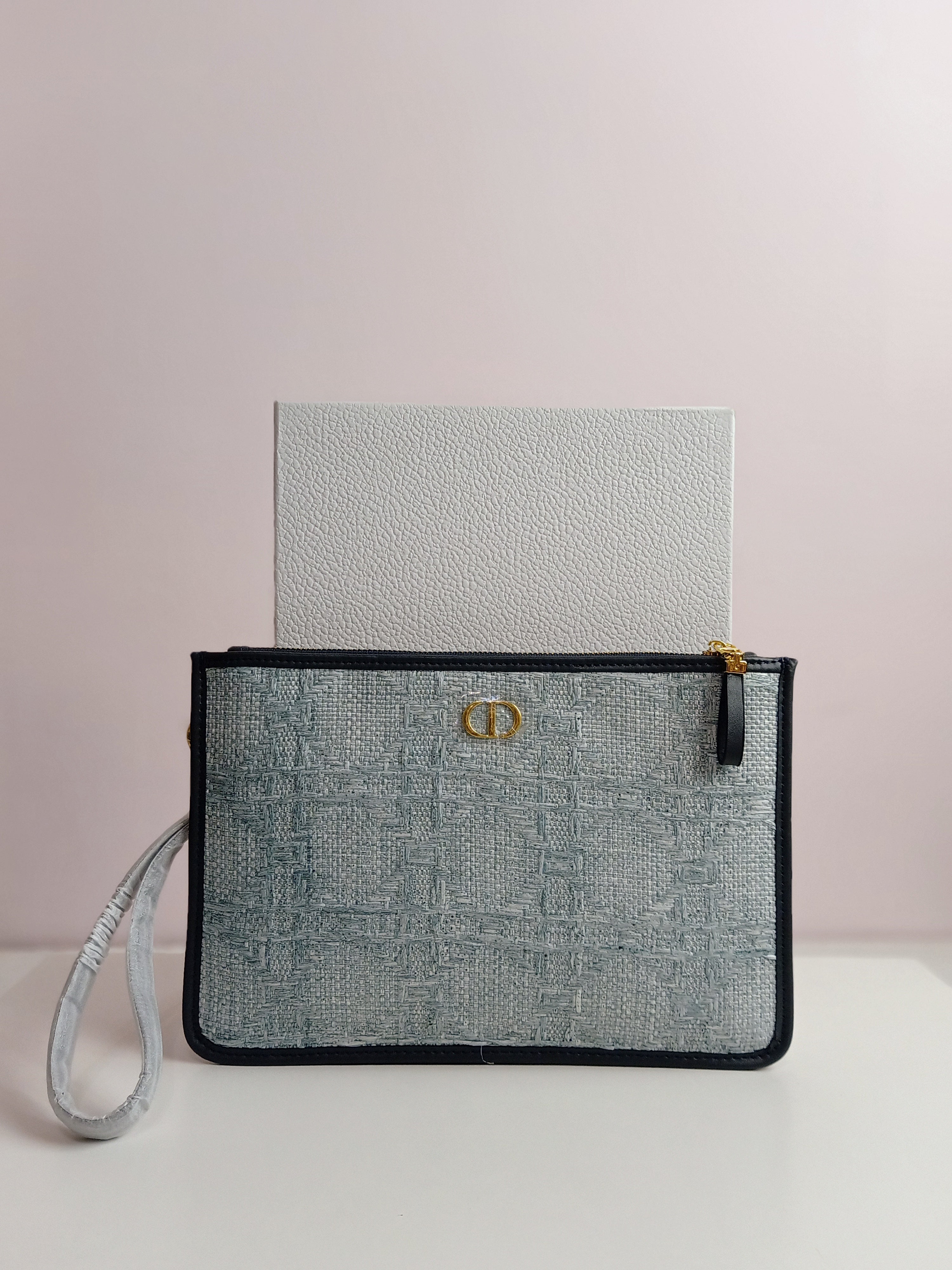 Dior clutch in light blue jeans