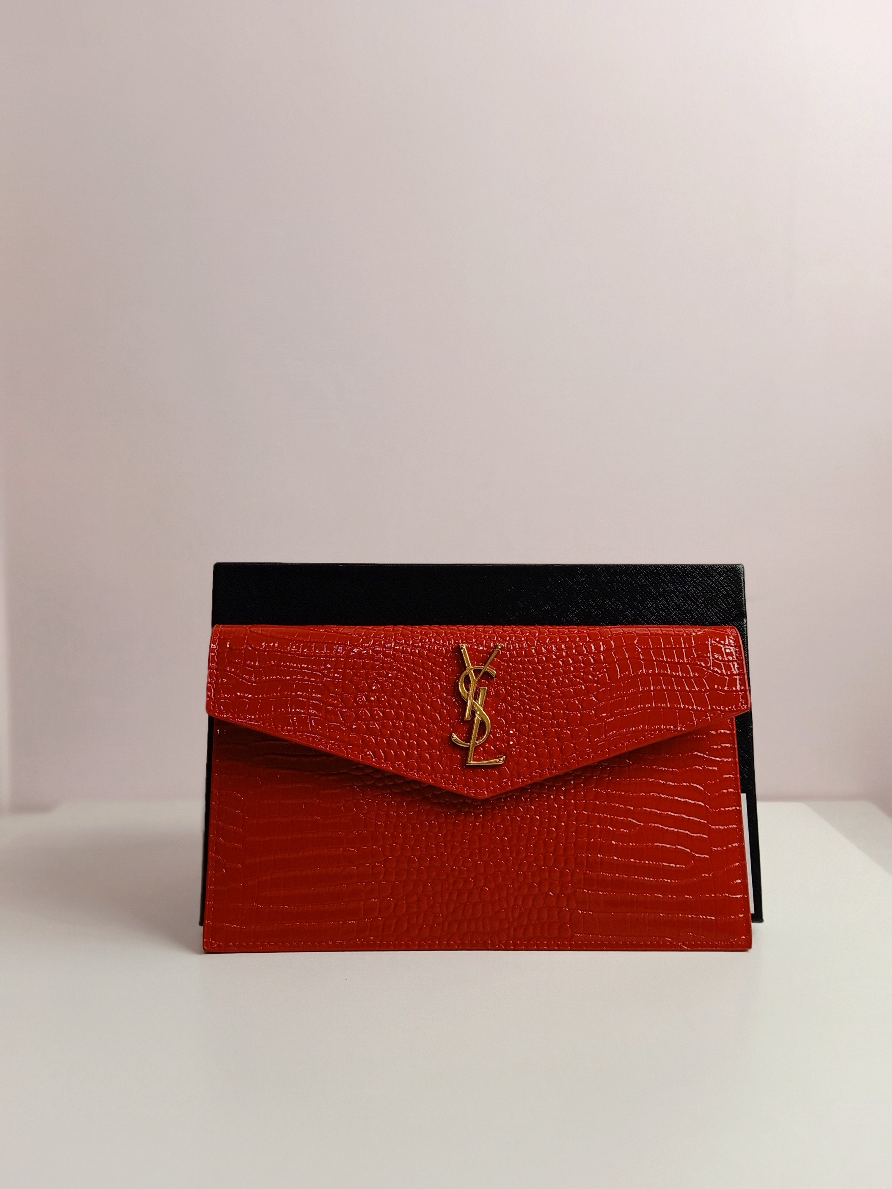 YSL clutch in shiny red-gold