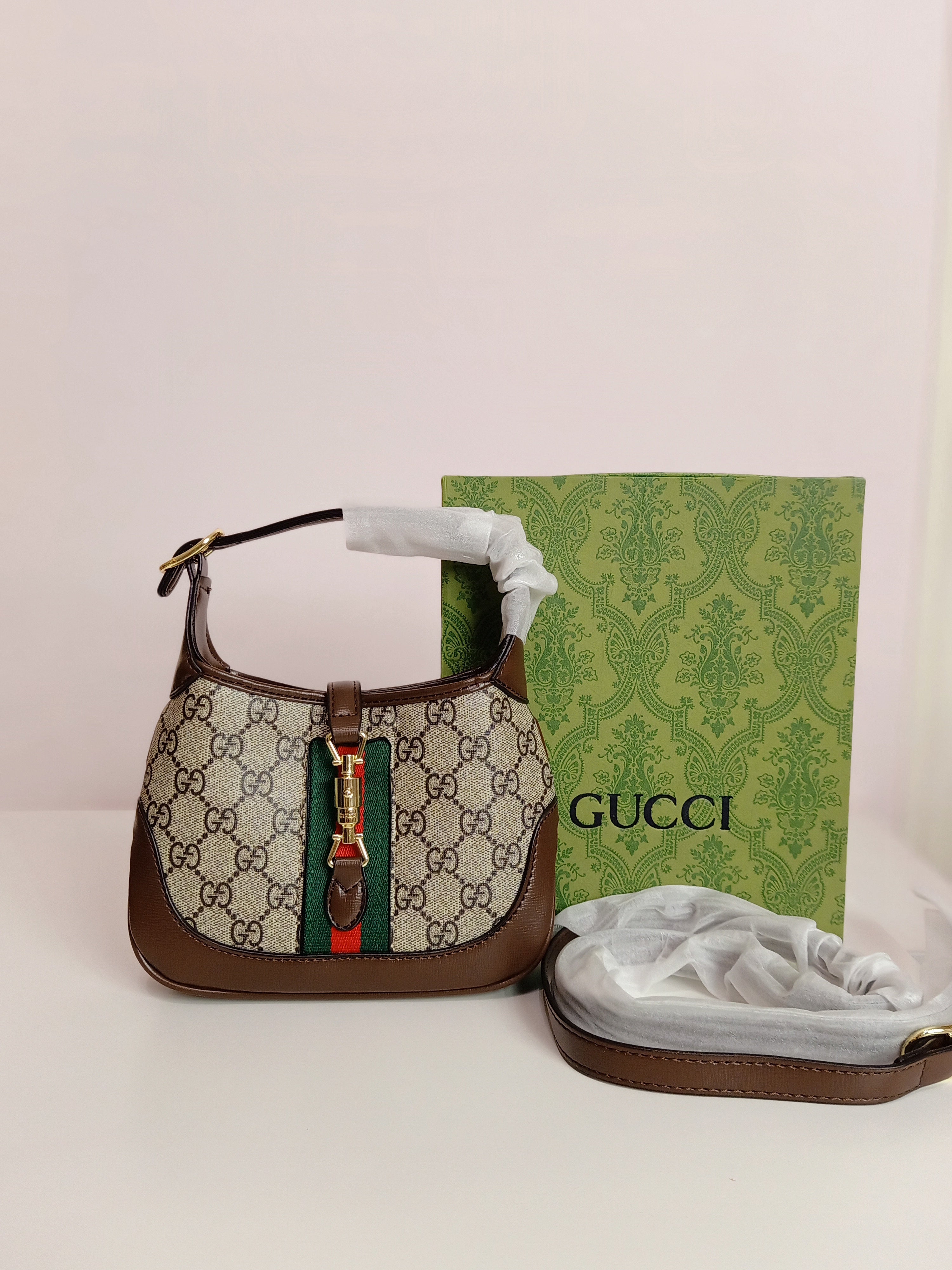 Gucci small cross body bag in brown